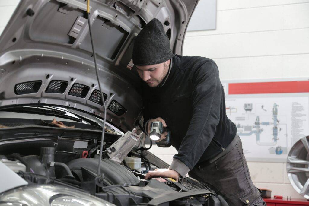 Man inspecting car engine