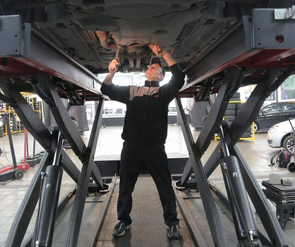 Mechanic smiling at camera
